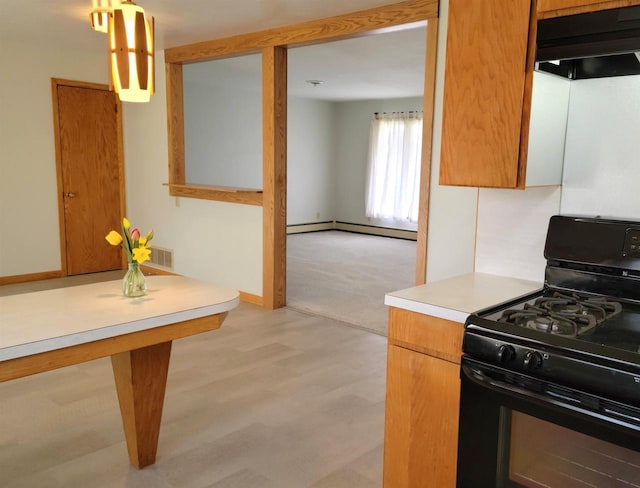 kitchen with black gas range, under cabinet range hood, light wood-style floors, light countertops, and baseboard heating