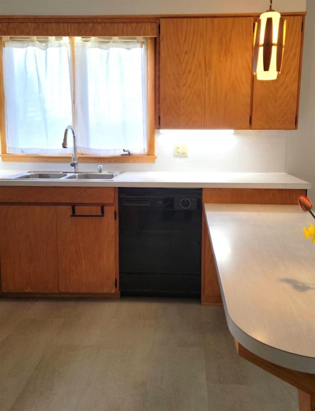 kitchen with light countertops, a healthy amount of sunlight, dishwasher, and a sink