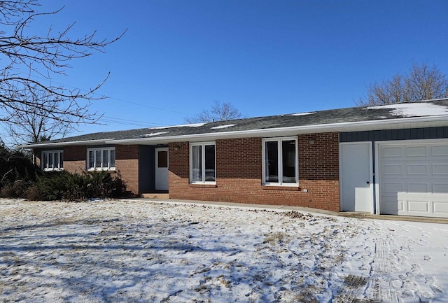 ranch-style home with an attached garage and brick siding