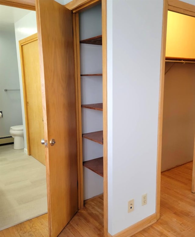 closet featuring a baseboard radiator