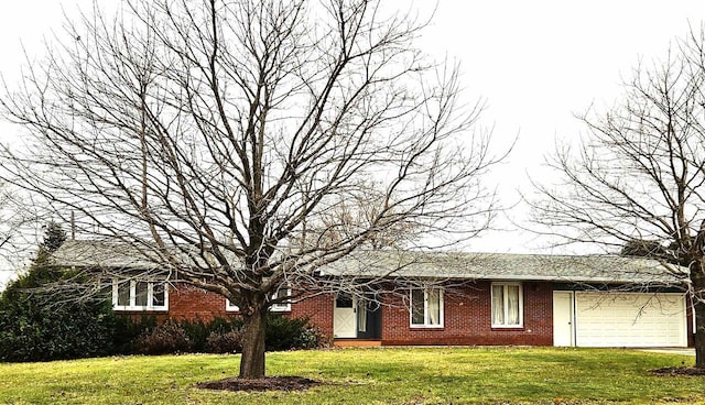 ranch-style house with a garage, a front yard, and brick siding