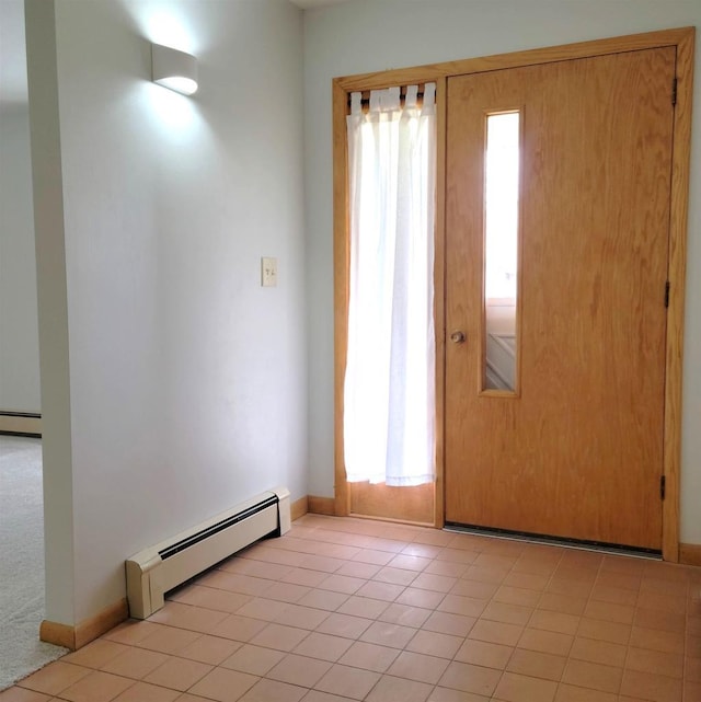 foyer entrance with a baseboard radiator and baseboards