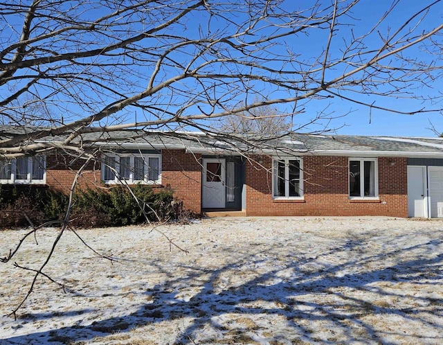 single story home featuring brick siding