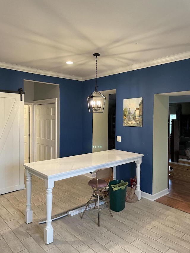 dining space featuring ornamental molding, a barn door, and light wood-type flooring