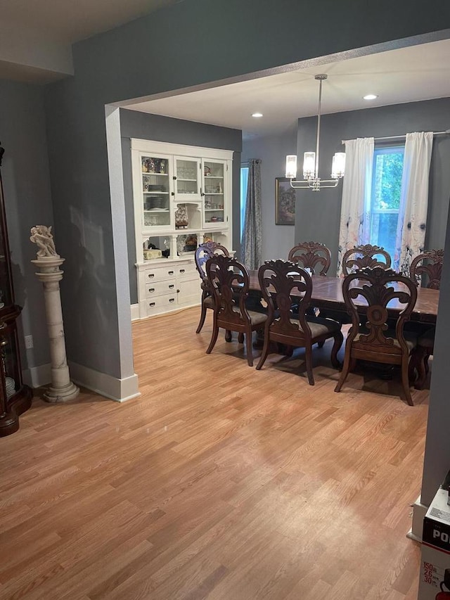 dining room featuring an inviting chandelier and light wood-type flooring