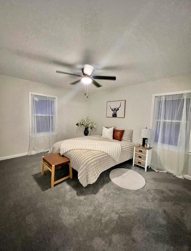 carpeted bedroom with a textured ceiling and ceiling fan