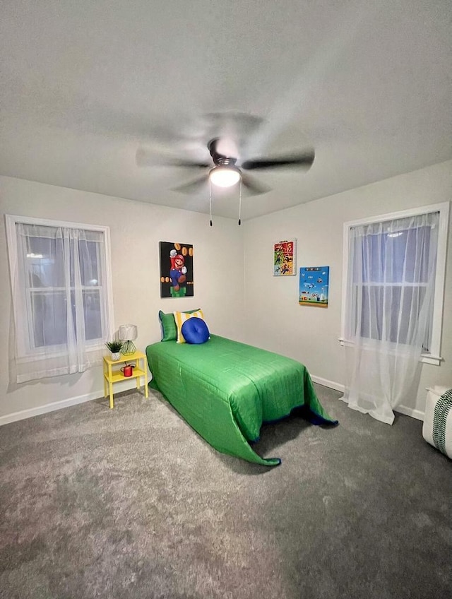 carpeted bedroom with ceiling fan and a textured ceiling