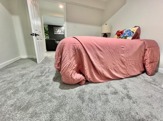 carpeted bedroom featuring lofted ceiling