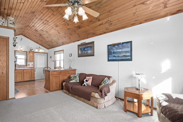 carpeted living room with ceiling fan, high vaulted ceiling, sink, and wooden ceiling