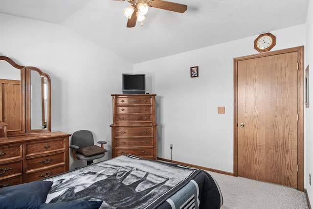 bedroom with carpet floors, ceiling fan, and vaulted ceiling