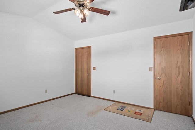 unfurnished room featuring lofted ceiling, light carpet, and ceiling fan