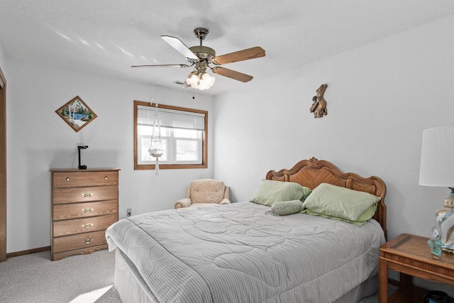 bedroom featuring ceiling fan and light carpet