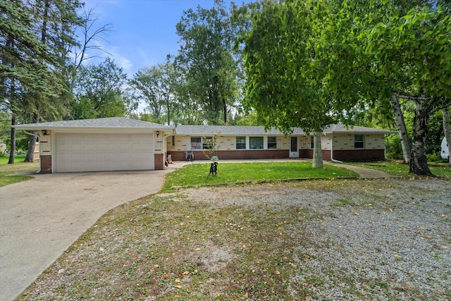 single story home featuring a garage and a front yard