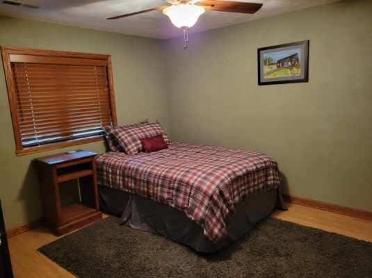 bedroom with ceiling fan and hardwood / wood-style floors