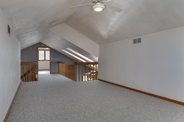 additional living space featuring lofted ceiling, light carpet, and ceiling fan