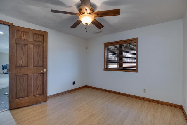 unfurnished room with ceiling fan and light wood-type flooring