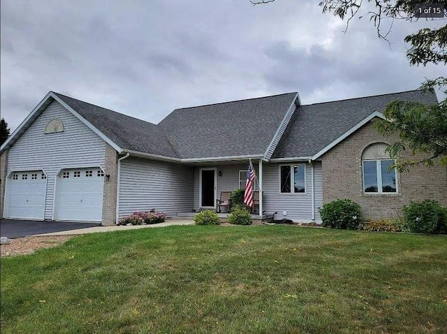 single story home featuring a garage and a front yard