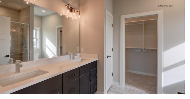 bathroom with toilet, an enclosed shower, and vanity