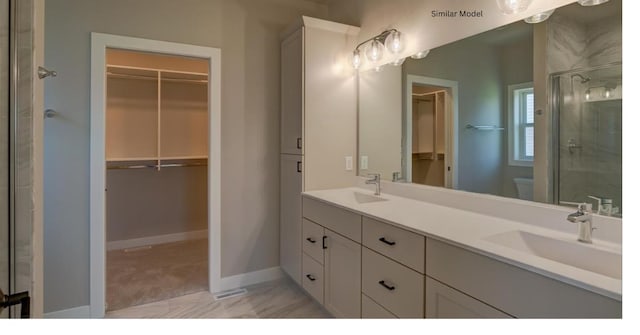 bathroom with a shower with door, toilet, and vanity