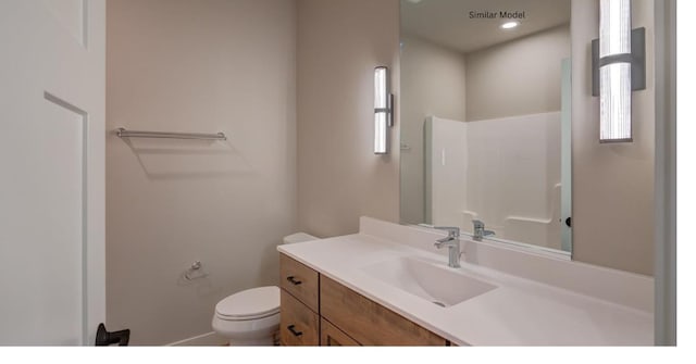 bathroom with toilet and vanity