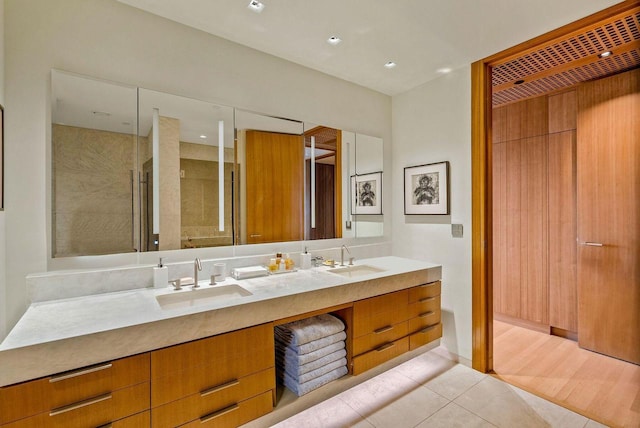 bathroom featuring vanity, an enclosed shower, and tile patterned flooring