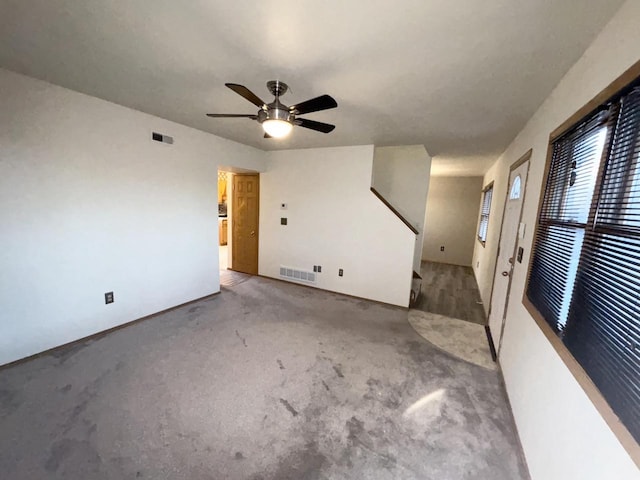 spare room featuring ceiling fan and light colored carpet