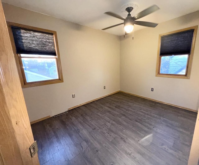 unfurnished room with ceiling fan and dark hardwood / wood-style flooring