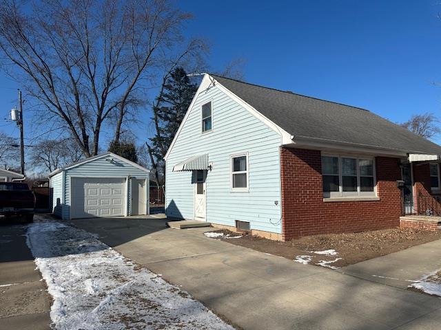 view of front of home featuring a garage and an outdoor structure