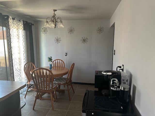 tiled dining area with a chandelier