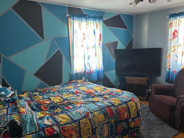 bedroom featuring multiple windows, track lighting, and ceiling fan