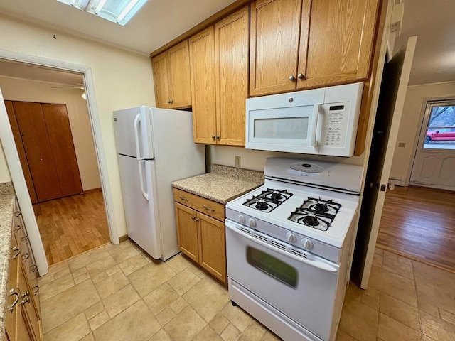 kitchen featuring white appliances and light hardwood / wood-style floors