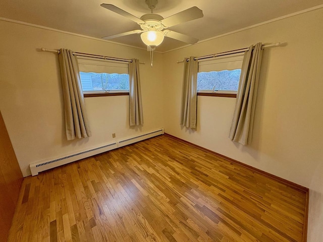 empty room with baseboard heating, ceiling fan, light hardwood / wood-style floors, and a wealth of natural light