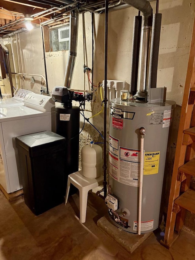 utility room with washing machine and dryer and water heater