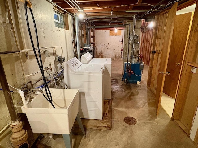 clothes washing area with sink and washing machine and dryer