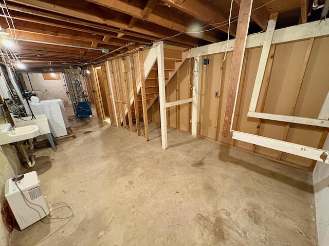 basement featuring washer / dryer and sink