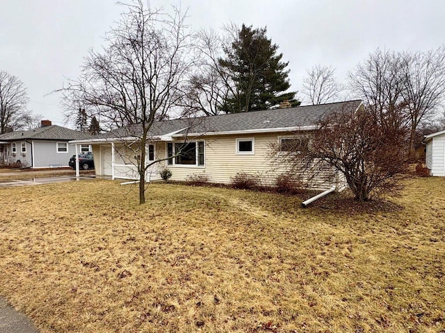 rear view of house featuring a lawn