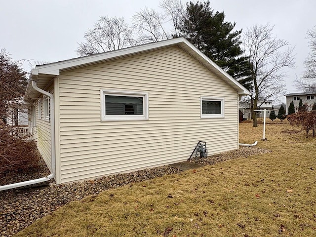 view of side of home with a lawn