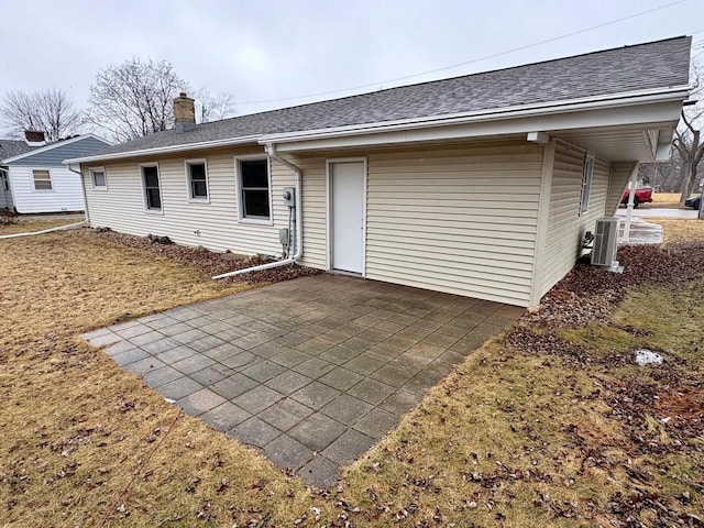 rear view of property with a patio and central air condition unit