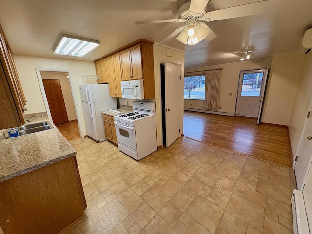 kitchen with sink, white appliances, a baseboard radiator, and ceiling fan