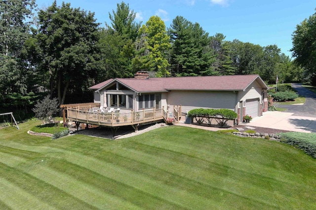 view of front of house with a garage, a front yard, and a deck