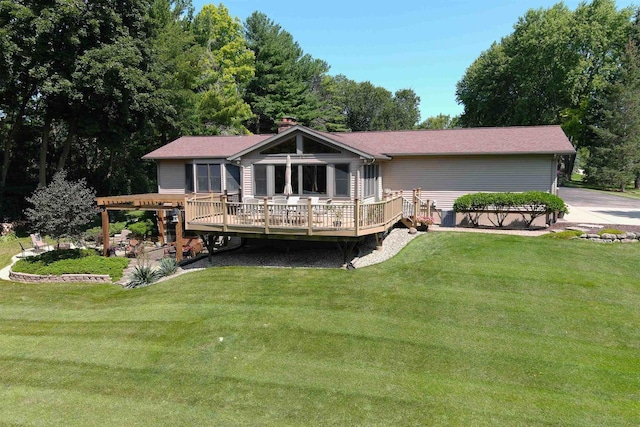 back of property featuring a yard and a deck