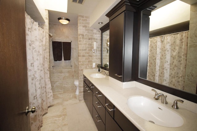 bathroom with vanity, toilet, and tile walls