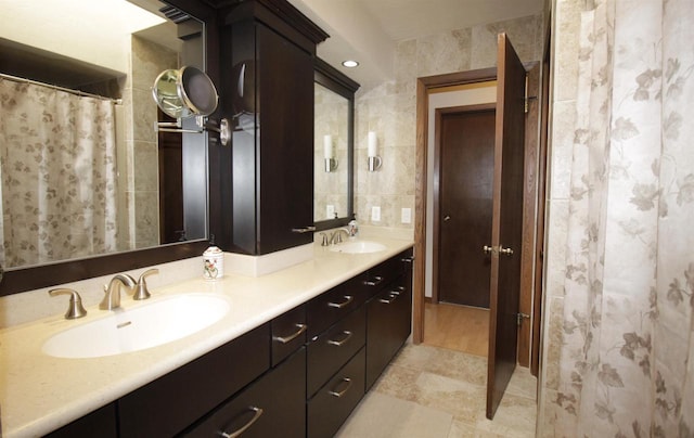 bathroom with vanity and tile walls