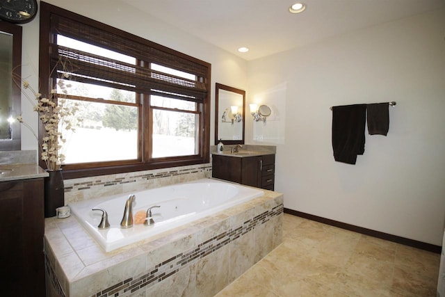 bathroom featuring vanity and tiled bath