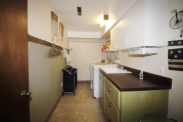 laundry area featuring independent washer and dryer and cabinets