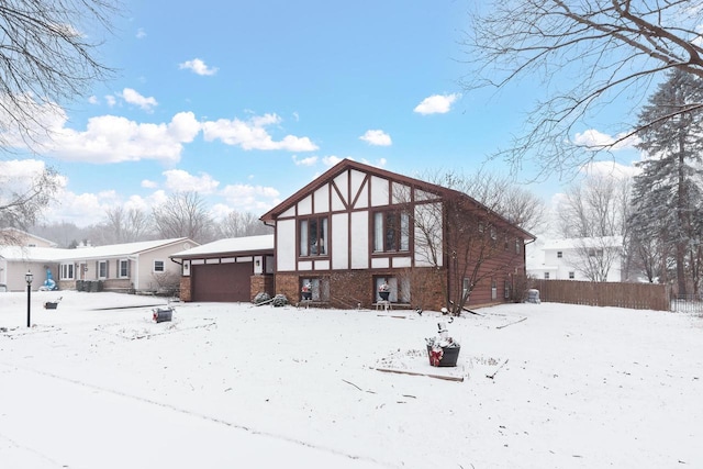 snow covered house with a garage