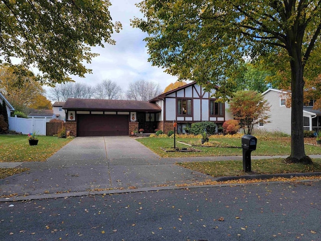 view of front of house with a garage and a front lawn