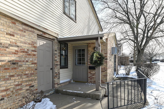 view of snow covered property entrance