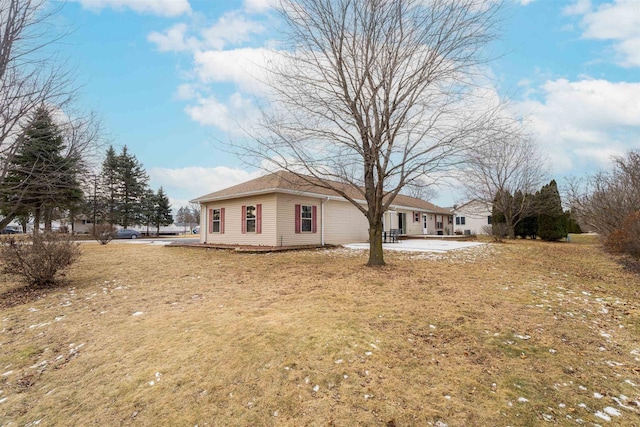 view of front of property featuring a front lawn and a patio