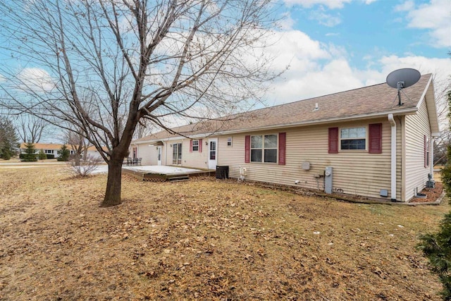 rear view of house featuring a deck, a lawn, and central air condition unit